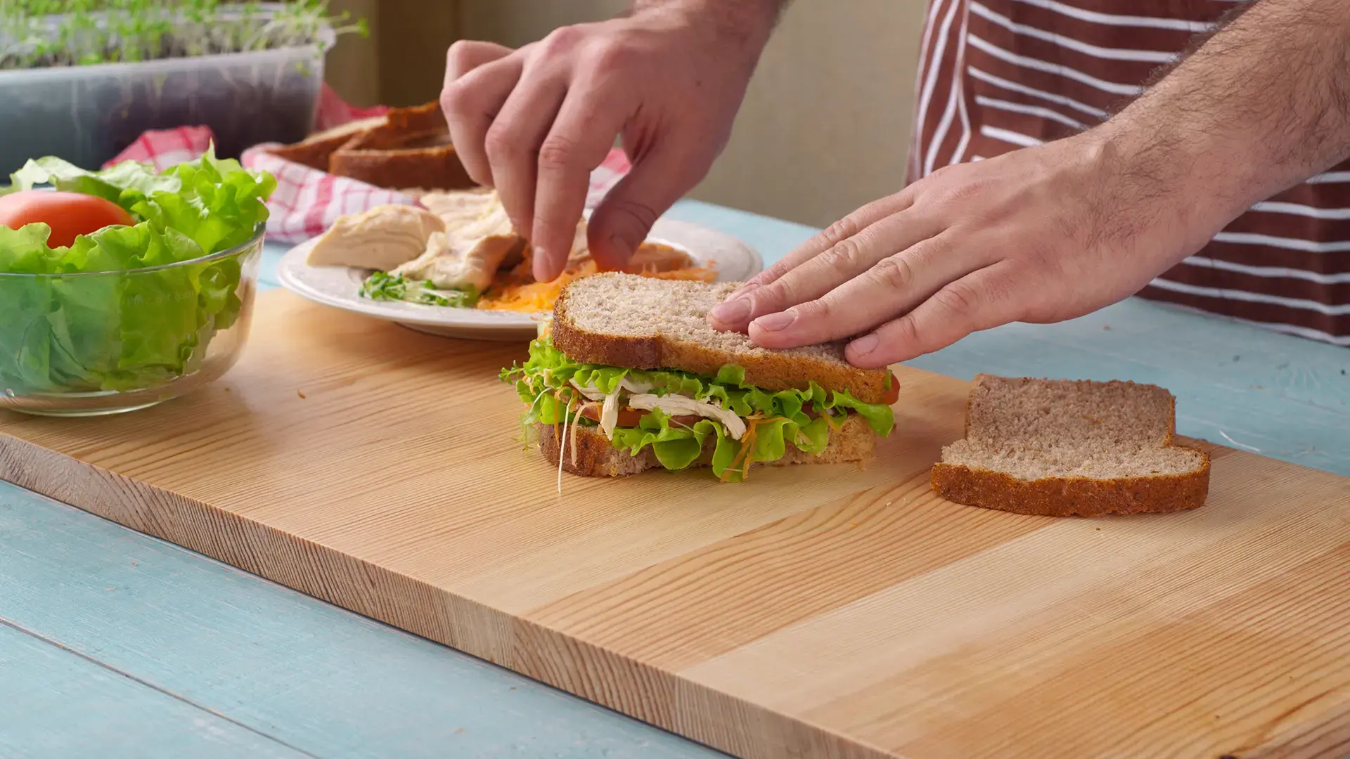 Man cooking big sandwich with chicken