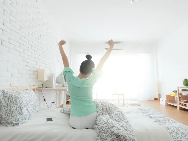 Young Woman Stretching on the bed